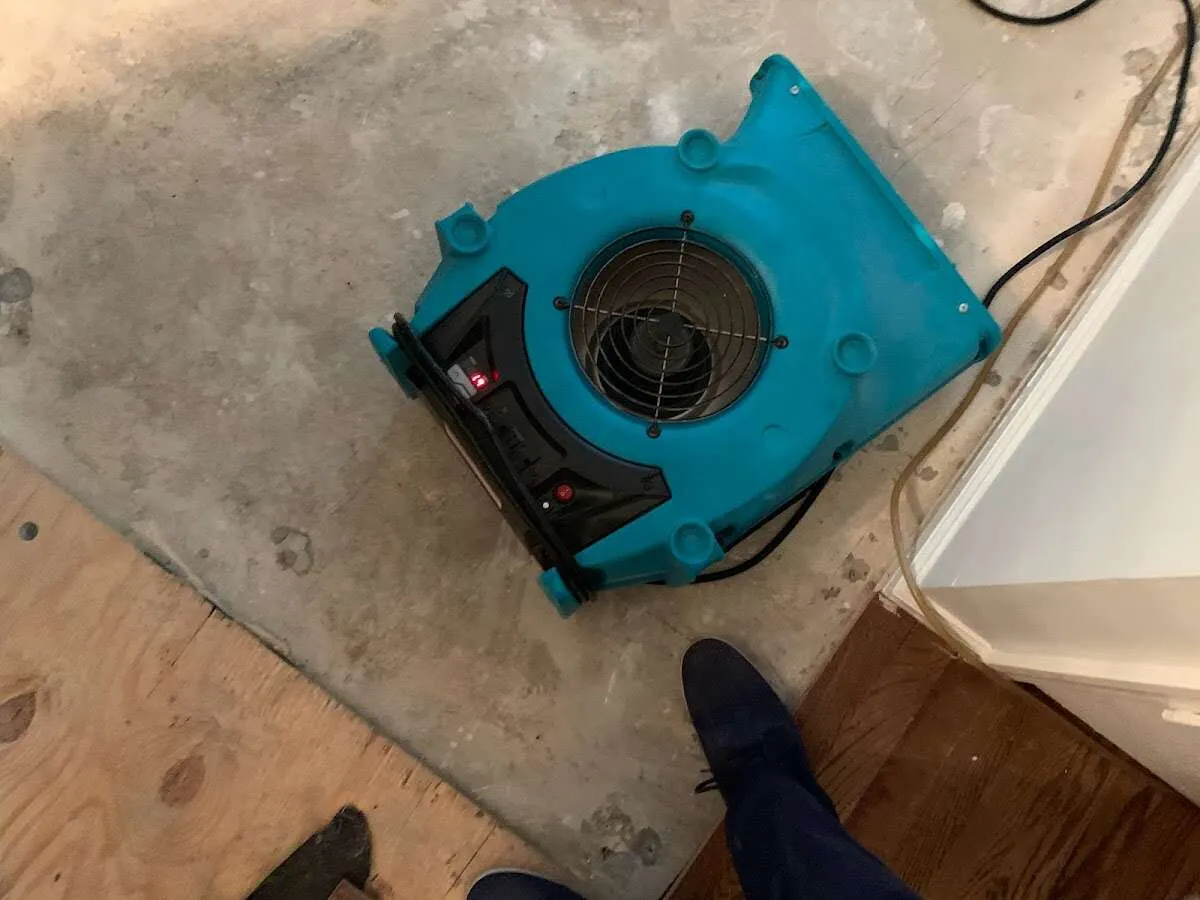 Air mover drying subfloor during Commercial Water Damage Restoration in East Honolulu